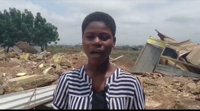 Student in front of the demolished building