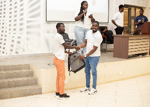 A participant, left, receiving a package in Kumasi