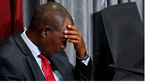 Kenya's National Treasury Cabinet Secretary Njuguna Ndung’u holding his head down