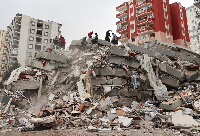 Rescue teams search through rubble of collapsed buildings in Turkey after a 7.8-magnitude earthquake