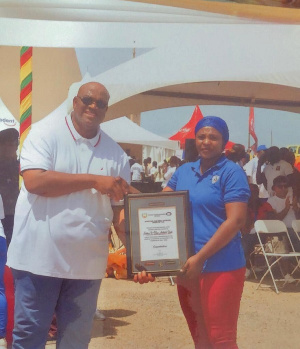 Regional Minister Hon. Henry Quartey Presenting The Award To Sister IS HAQ ABDUL HAKI88.jpeg