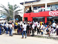 Some customers seated on plastic chairs