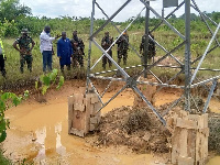 Some officers from GRIDCo at a transmission tower