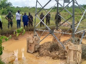 Some officers from GRIDCo at a transmission tower