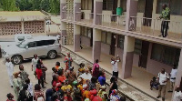 This image shows Simon Osei-Mensah engaging caterers from the balcony