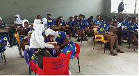 Students of T.I Ahmadiya SHS sitting on plastic chairs