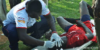 Kotoko's medic, Andrew Owusu treating one the BYA players.