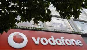 Vodafone branding is seen outside a retail store in London on November 12, 2013