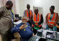 Former President Flt Lt Jerry John Rawlings holding his copy of the Ghana Card