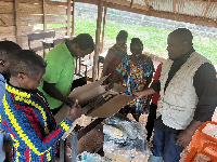 Dumelo (right) hands over some of the donations