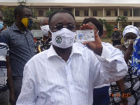 Minister for Food and Agriculture, Dr. Owusu Afriyie Akoto showing his voters ID card