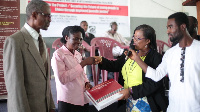 Mrs. Asare , (second from right) presenting copies of the legal documents to Mrs. Narh