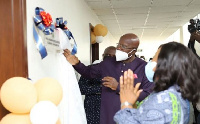 Mr Agyeman unveiling the plaque, with Mrs Botchwey clapping