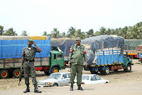 Nigerian security stand guard near the Nigerian-Benin border