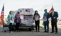 US Embassy and Health Ministry official receive the consignment at KIA