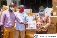 Hon Andrew Egyapa Mercer present the items to the hospital