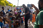 A volunteer of Afrikicks Foundation handing out an item