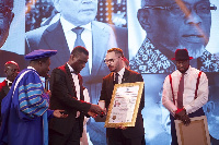 Emad Deraz, Executive Director of Gold Coast Refinery (right), receiving the award