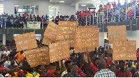 Aggrieved lotto writers holding placards to protest against the reduction of their commission