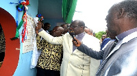 Rt Rev Prof Mante(middle) unveiling the plaque to inaugurate the centre