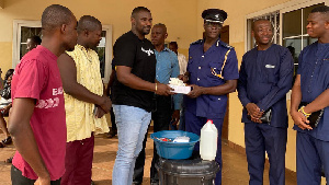 John Dumelo donating items to the Ayawaso West police officers