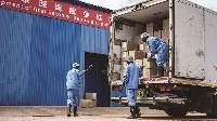 Workers load anchovy products into a truck in Kwale, Kenya