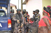 Some residents and police personnel at the chief's palace