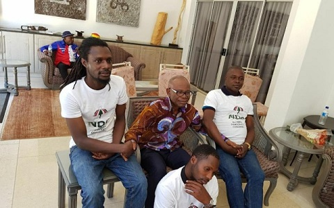 Ayisi-Boateng  in a picture with three men wearing NDC T-shirts