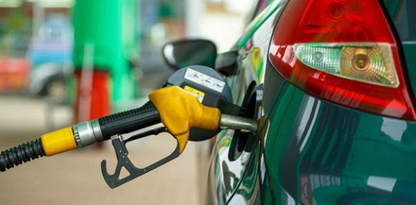 A fuel attendant serving a customer