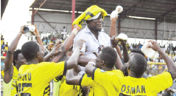 Coach and players of Ashgold jubilating