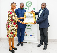 Catherine Edusei and Anthony Tamakloe of Green Label receiving the award from Hector Wulff