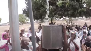 The residents rush for water that they are seeing in their community for the first time