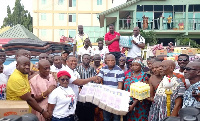 Samuel Okudzeto Ablakwa receiving the items from the ECG Accra East staff