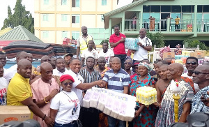 Samuel Okudzeto Ablakwa receiving the items from the ECG Accra East staff