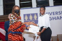 Dr. Joanna Boampong presenting a certificate