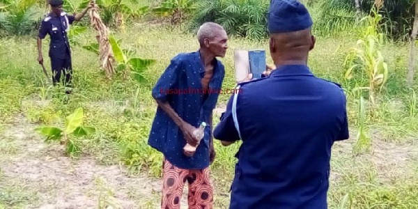 Opanin Kwadwo Sampene with some police officers on the farm