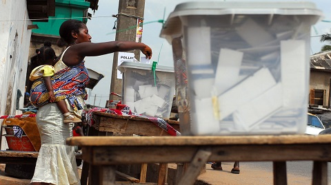 File: A woman casting her vote during a poll