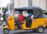 File Photo: A tricycle rider with passengers