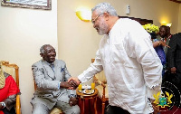 Former President Jerry John Rawlings in a handshake with Former President John Agyekum Kufuor