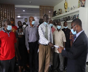 Ex-staff of KNUST presenting a letter to register their displeasure