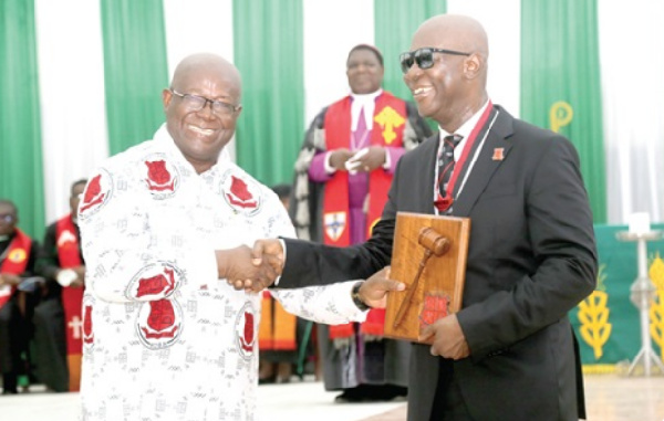 Moses Kwesi Baiden Jr. (right),  President for MOBA, at the induction ceremony