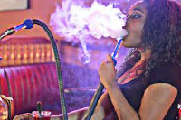 A lady smoking Shisha