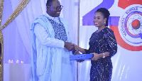 Kweku Mensah-Bonsu, Chairman of Primetime presenting the award to Adjasi of the Medifem Hospital