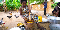 File Photo: A woman pounding palmnuts in a local kitchen