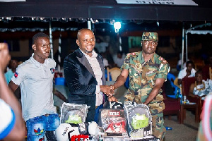 Sammy Anim presenting the boxing items to the training school