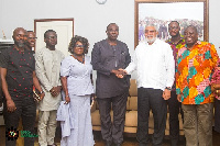 Former President John Rawlings in a handshake with Dr. Ekwow Spio-Garbrah