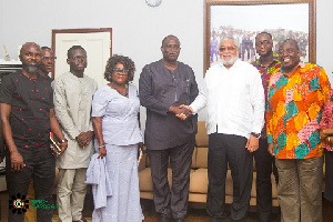 Former President John Rawlings in a handshake with Dr. Ekwow Spio-Garbrah