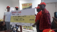 Officials of Ashanti Foam Ghana Limited presenting the cheque to the Ghana Olympic Committee