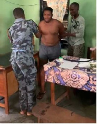 The suspect (bare chested) with the two policemen