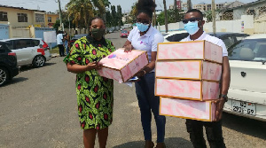 Mother of 9-year-old Oswald, Rita Gennuh receiving some gifts on behalf of her son